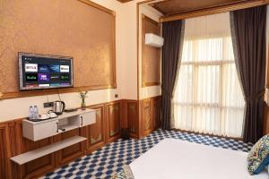 a hotel room with a bed and a flat screen tv at Epicenter Hotel Baku in Baku +21 photos