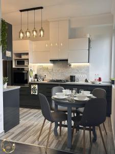 a kitchen with a table and chairs in a room at Ural Home in Székesfehérvár