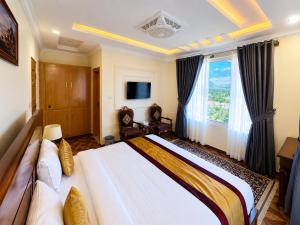 a bedroom with a large bed and a large window at Relax in in Skardu