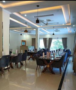a dining room with tables and chairs in a room at Relax in in Skardu
