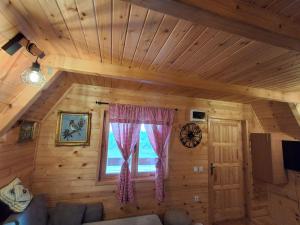 a living room with a couch and a window at Domaćinstvo braća Rebić in Gacko
