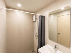 a bathroom with a shower and a sink and a mirror at Pool Studio Near BTS Quiet Stay in Amphoe Phra Khanong +15 photos