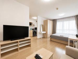 a living room with a large flat screen tv at Pool Studio Near BTS Quiet Stay in Amphoe Phra Khanong