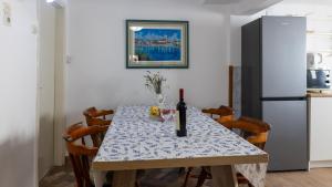 a kitchen with a table with a bottle of wine on it at House Antonia by Villas Guide in Opuzen