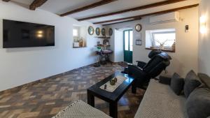 a living room with a couch and a table at House Antonia by Villas Guide in Opuzen