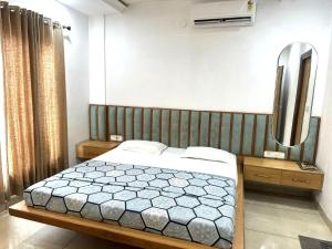 a bedroom with a bed and a mirror at K D Motels in Patiāla