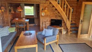 a living room with a couch and a table at Feriennest Buendorf in Dahlenburg