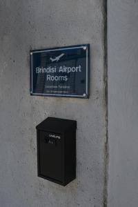 a sign on the side of a wall with a box at Brindisi Airport Rooms in Brindisi +17 photos