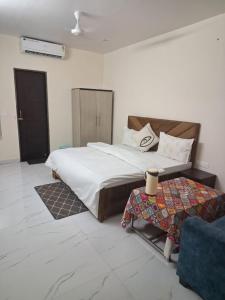 a bedroom with a large bed and a table at Sundervan Resort in Alwar