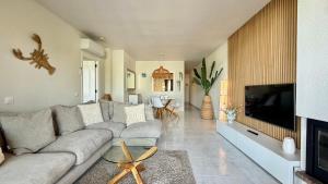 a living room with a couch and a tv at Puig Sa Guilla 1C B2 in Pals