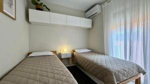 two beds in a small room with a window at Puig Sa Guilla 1C B2 in Pals +37 photos