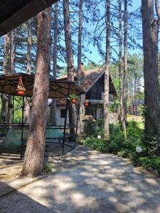 a house with a gazebo in the woods at Radicini konaci in Vinci