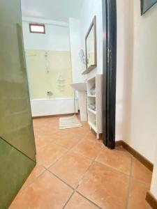 a bathroom with a tub and a sink and a mirror at GMD Sweet Home in Policoro