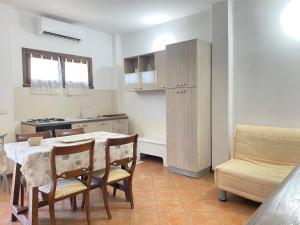 a kitchen and dining room with a table and chairs at GMD Sweet Home in Policoro