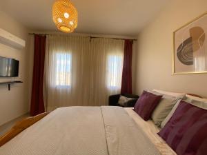 a bedroom with a large bed and a couch at Mountain View luxe chalet Ras elhikma families only in Ras Elhekma