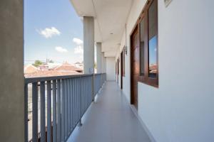a balcony of a building with a view of the city at RedDoorz Plus at Kencana Residence Jimbaran in Jimbaran +6 photos