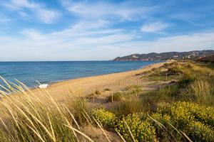 a sandy beach with a fence and the ocean at Kampaoh Costa Brava in Pals +34 photos