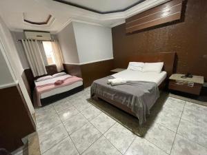 a hotel room with a bed and a window at Hotel Vitória de Santos in Santos +60 photos