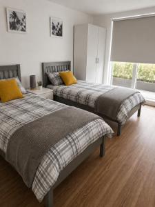 a bedroom with two beds and a window at Gillingham One in Gillingham
