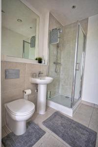 a bathroom with a toilet and a sink and a shower at Gillingham One in Gillingham +4 photos