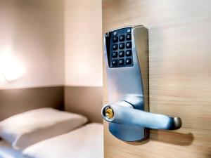 a close up of a door with a remote control at B&B HOTEL Wien-Heiligenstadt in Vienna +22 photos