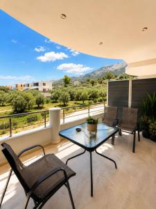 a patio with a table and chairs on a balcony at Danita Apartments 3 in Paleros