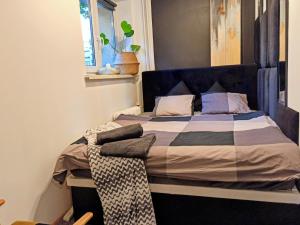 a bed with a blue headboard in a room at Studio Park Śląski Katowice/Chorzów in Chorzów