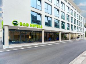 a large white building with a big hotel sign on it at B&B HOTEL Klagenfurt-City in Klagenfurt