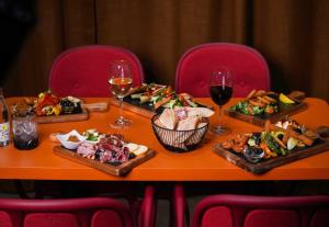 a table with three plates of food and glasses of wine at B&B HOTEL Paris 17 Batignolles in Paris