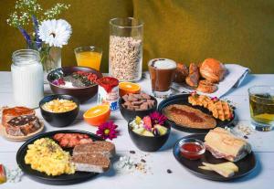 a table with many different types of breakfast foods at B&B HOTEL Paris 17 Batignolles in Paris