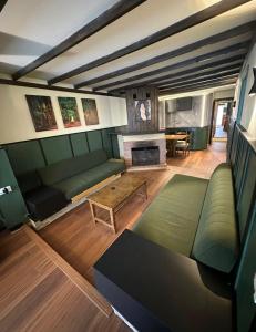 a living room with a couch and a fireplace at Mon Refuge 123 in Bcharré