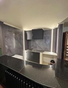 a kitchen with a black counter top in a room at Mon Refuge 123 in Bcharré