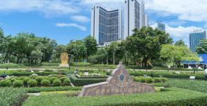 a garden in a park with buildings in the background at XXCASA Sukhumvit 39 คาซ่า สุขุมวิท 39 BTS ทองหล่อ in Klong Toi