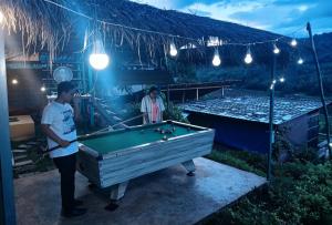 two men standing in front of a pool table at เวนิสบ้านเวร in Ban Khun Nam Nan