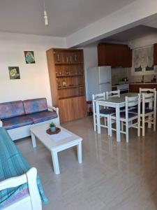 a living room with a couch and a table at Leonidas Apartments in Preveza