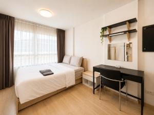a bedroom with a bed and a desk and a computer at Easy Access Studio Near BTS in Amphoe Phra Khanong +15 photos