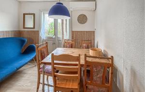 a dining room with a table and chairs and a blue couch at 2 Bedroom Pet Friendly Home In Haderslev in Haderslev