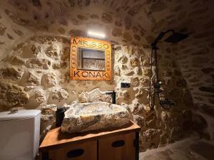 a bathroom with a sink and a stone wall at Mirisso Konak Mardin in Mardin