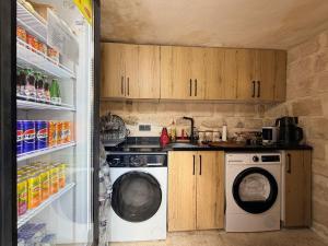 a kitchen with a washing machine and a refrigerator at Mirisso Konak Mardin in Mardin +20 photos