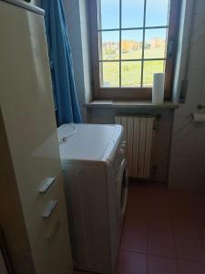 a washing machine in a kitchen with a window at La Rondine Atessa in Atessa +35 photos