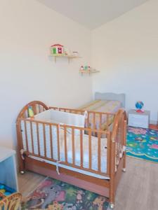 a baby crib in a room with ainylinylinylinylinylinylinylinyl at La Rondine Atessa in Atessa