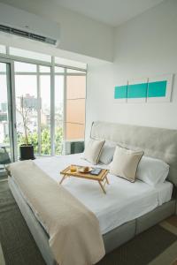 a bedroom with a large bed with a table on it at Icon 701- Stylish Loft W AC Premium Location in Mexico City