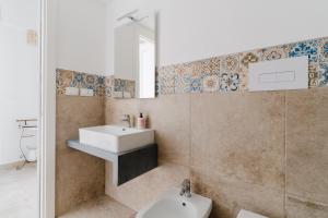 a bathroom with a sink and a mirror at Dimora storica Jolanda a Uggiano in Uggiano la Chiesa +37 photos