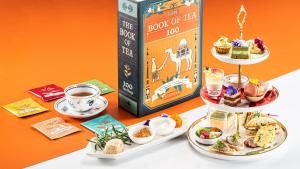 a table topped with plates of food and a book at Hotel Trusty Tokyo Bayside in Tokyo