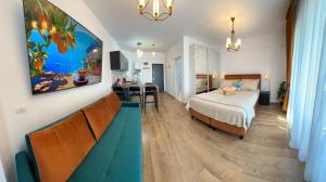 a hotel room with a bed and a kitchen at Saturn ROOMS in Saturn