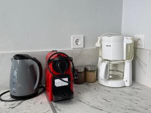 a kitchen counter with a coffee maker and a blender at Tête à Tête - Loft Apartment in Rhodes Town