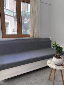 a bench in a room with a window at Tête à Tête - Loft Apartment in Rhodes Town