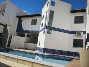 a building with a swimming pool in front of it at House Hotel Slz in São Luís