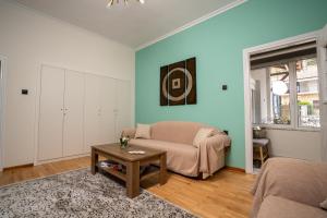 a living room with a couch and a table at Karydeones Living in Kleidoniá