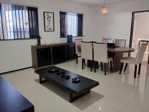 a living room with a table and a dining room at House Hotel Slz in São Luís